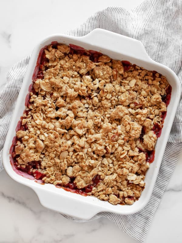 Cherry crumble in a square baking dish.