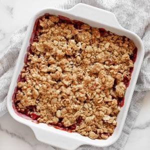 Cherry crumble in a square baking dish.