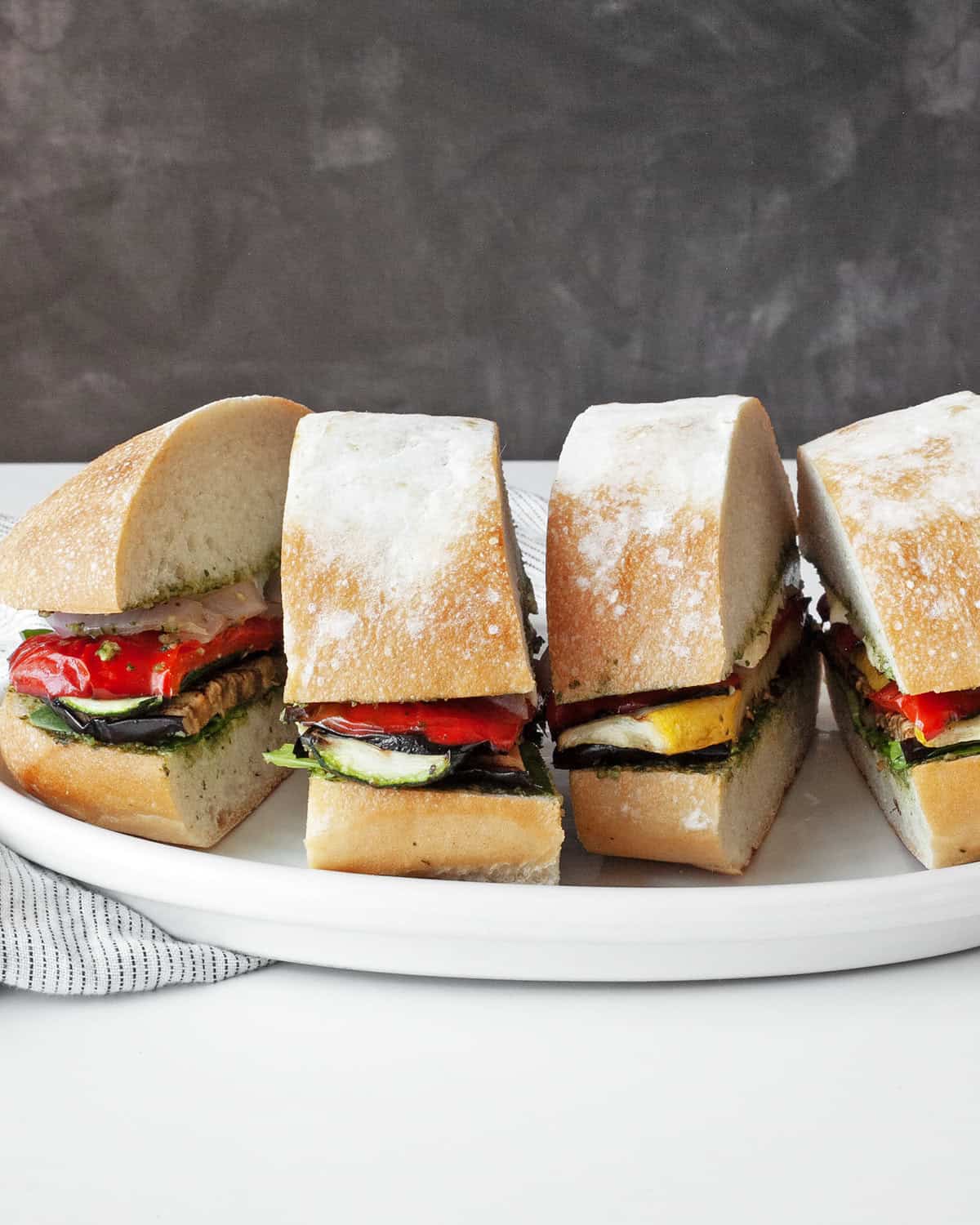 Grilled vegetable ciabatta sandwiches on a plate.