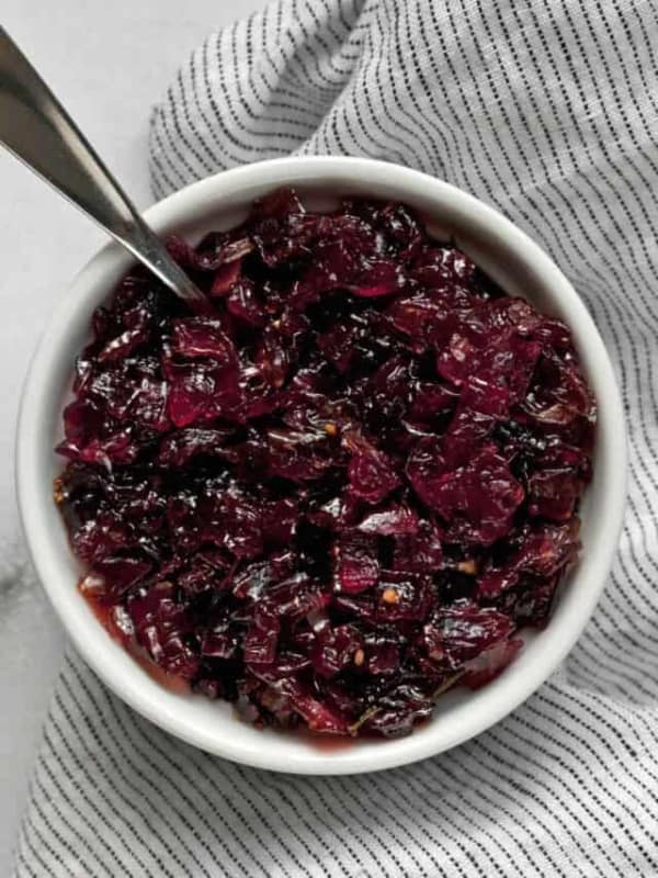 Onion jam in a bowl with a spoon.