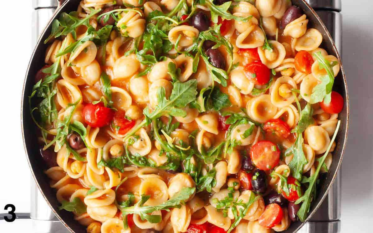 Arugula, tomatoes and parmesan stirred into cooked pasta.