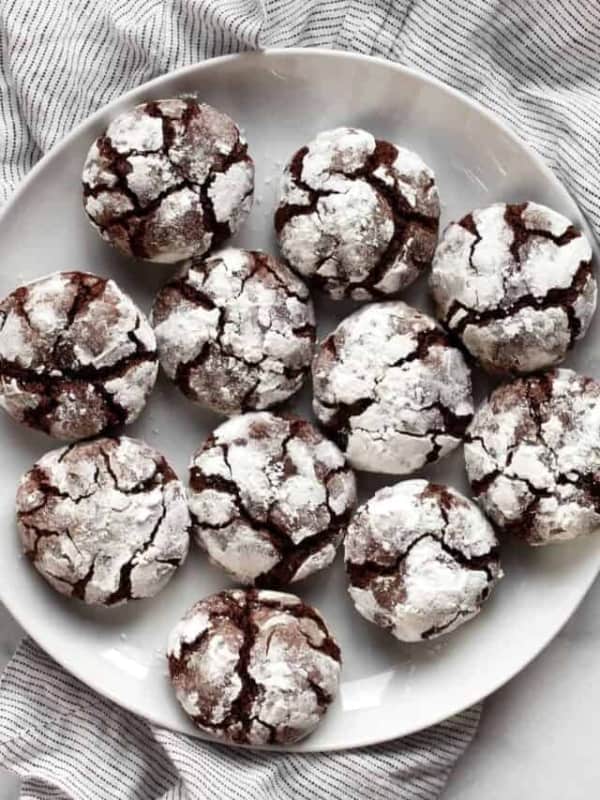 Chocolate crinkle cookies on a serving plate.