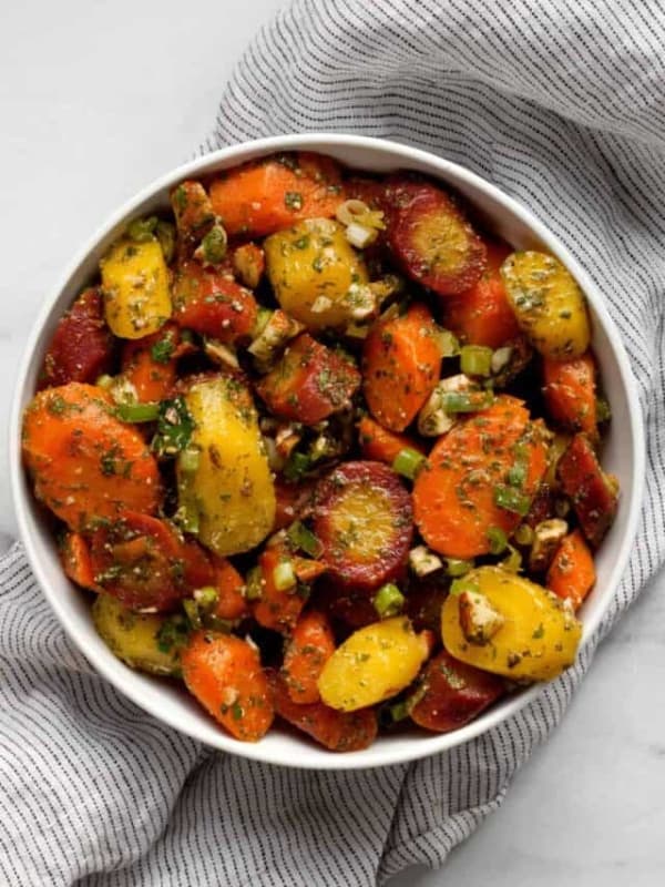 Moroccan carrot salad with almonds and scallions in a bowl.