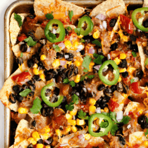 Veggie nachos baked on a sheet pan.