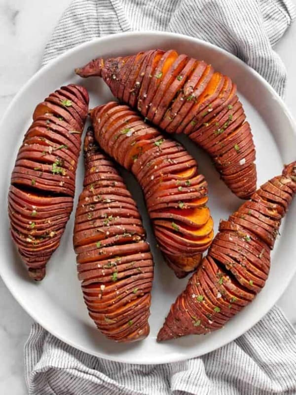 Hasselback sweet potatoes on a plate.