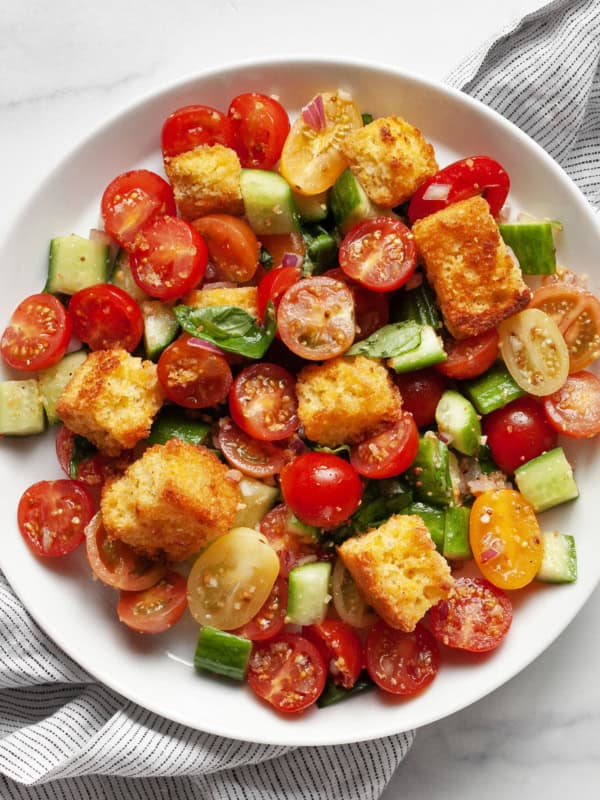 Panzanella salad with toasted cornbread on a plate.
