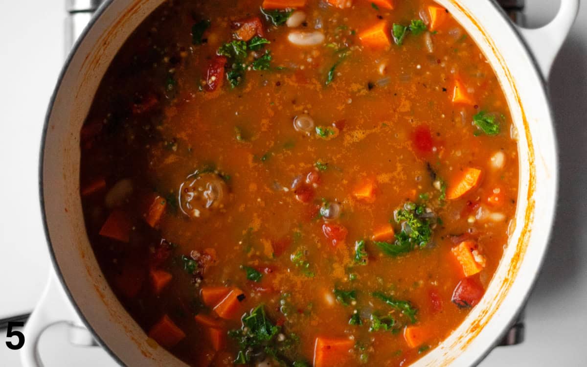 Soup simmered with kale in a large pot.