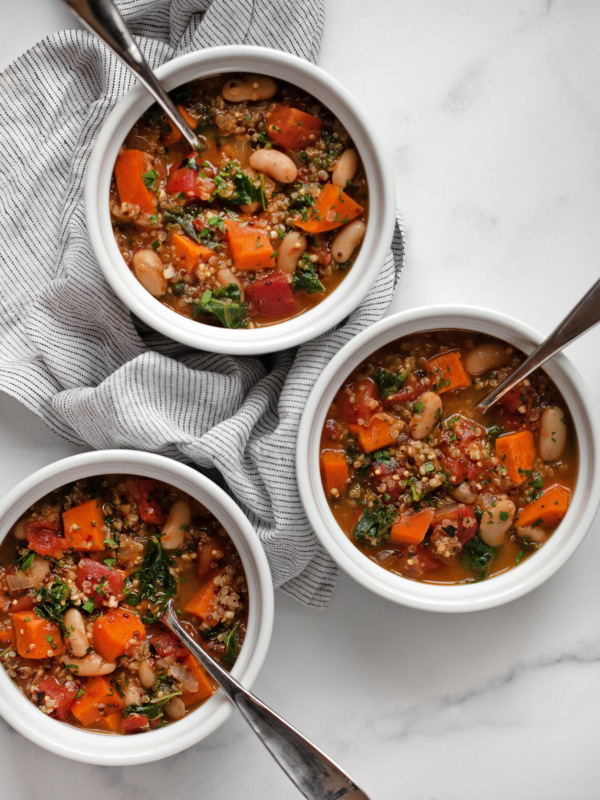 Three bowls of quinoa vegetable soup.