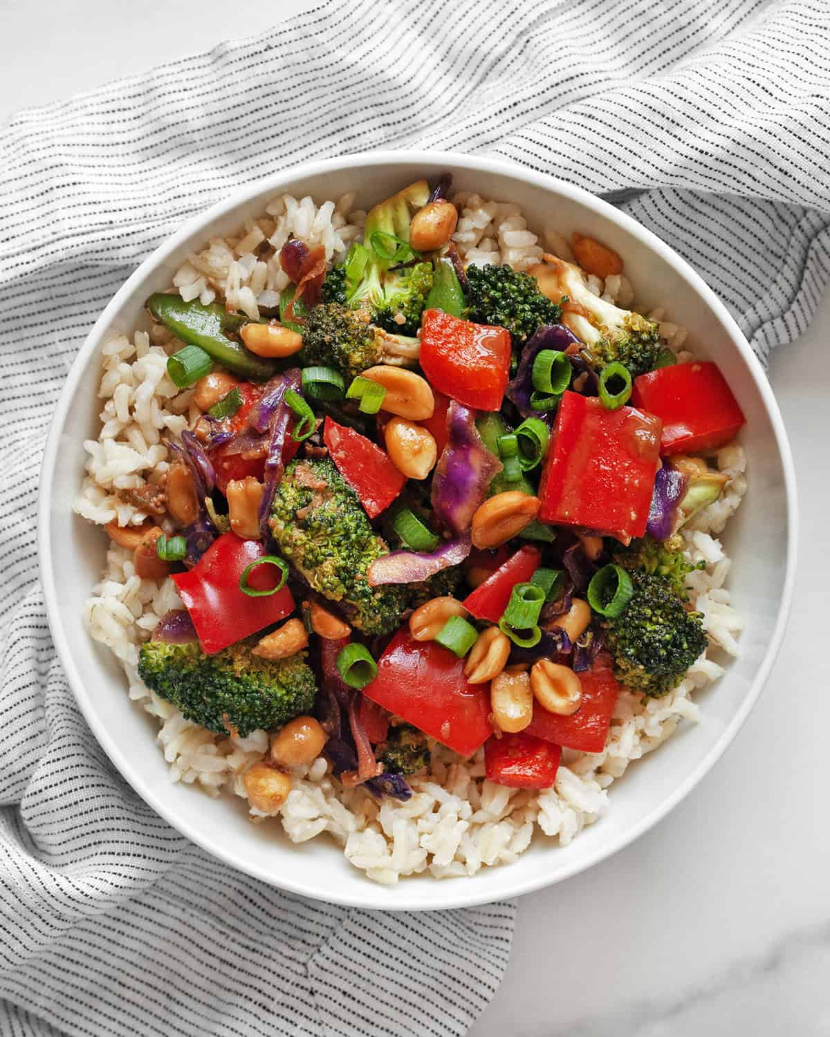 Easy veggie stir-fry in a bowl with brown rice.