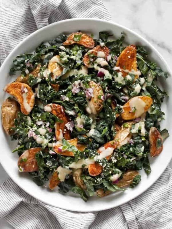 Roasted fingerling potato salad with kale on a plate.