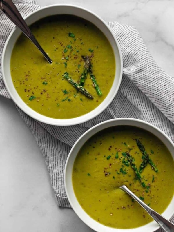 Two bowls of vegan roasted asparagus soup.