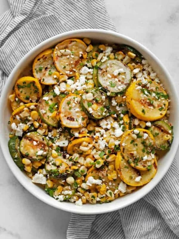 Grilled zucchini, yellow squash and corn in bowl.