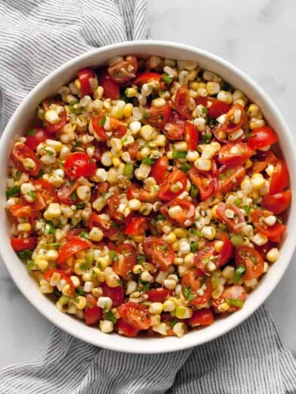 Fresh corn and tomato salad in a bowl.