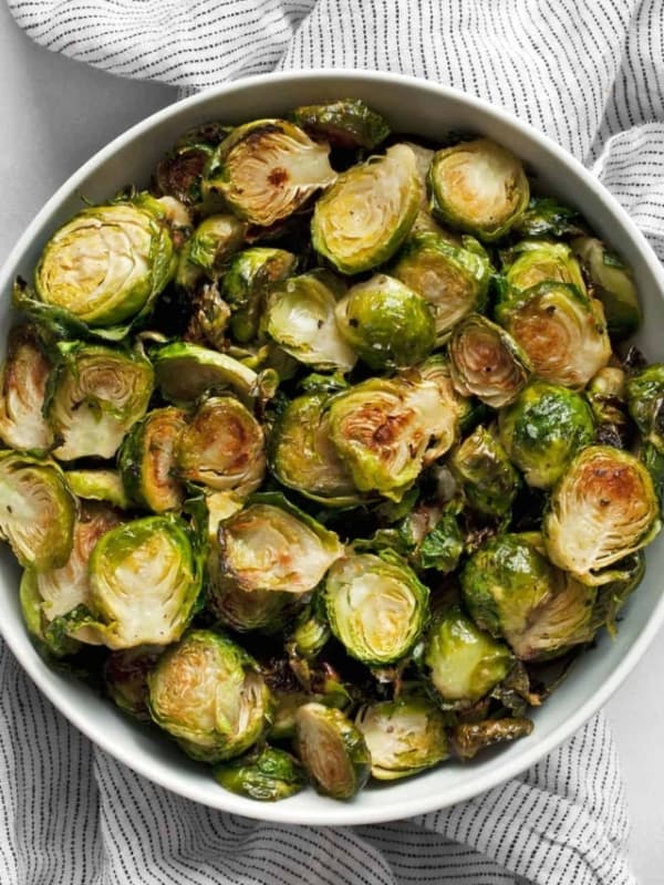 Thinly sliced crispy roasted brussels sprouts in a bowl.