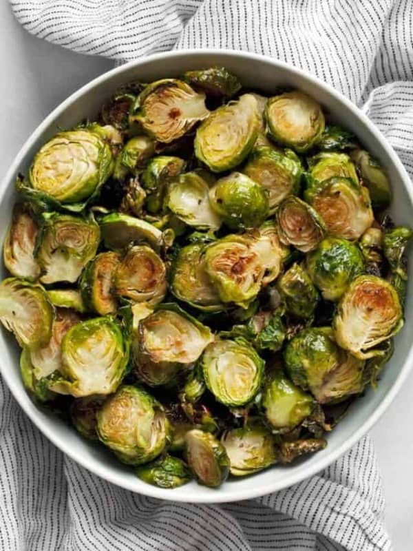 Thinly sliced crispy roasted brussels sprouts in a bowl.