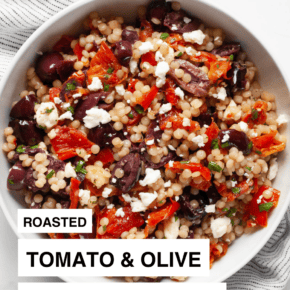 Tomato and olive pearl couscous in a bowl.