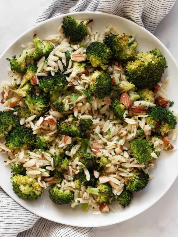 Orzo with roasted broccoli, almonds, lemon and garlic on a plate.