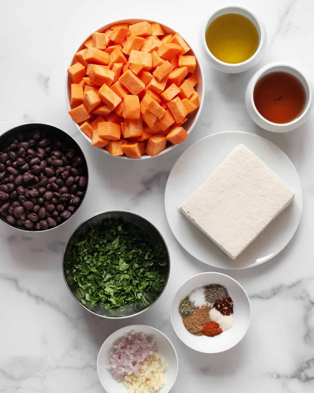 Ingredient including, tofu, sweet potatoes, black beans, parsley, olive oil, garlic, shallots, red wine vinegar and spices.