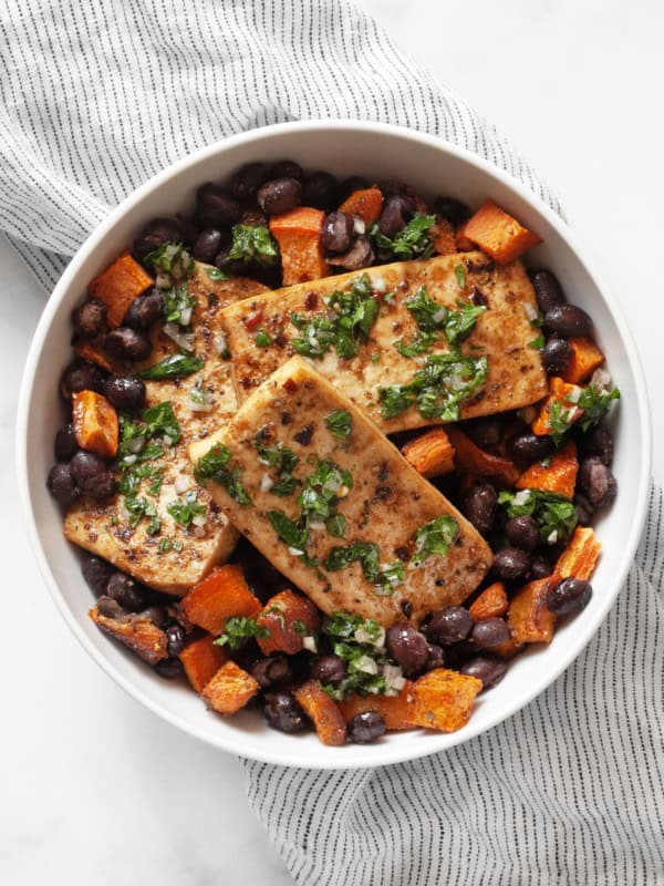 Sheet pan tofu, sweet potato and black beans in a bowl.