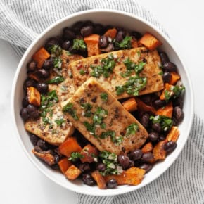 Roasted tofu, sweet potato and black beans in a bowl.