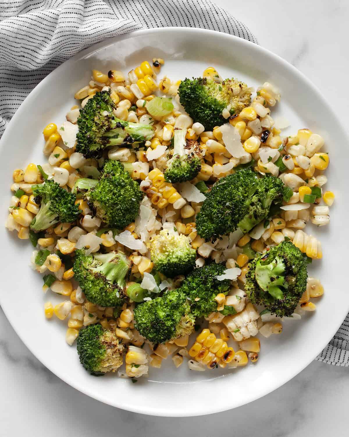 Grilled corn broccoli salad on a plate.