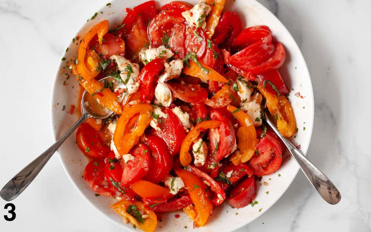 Salad tossed together in a large bowl.