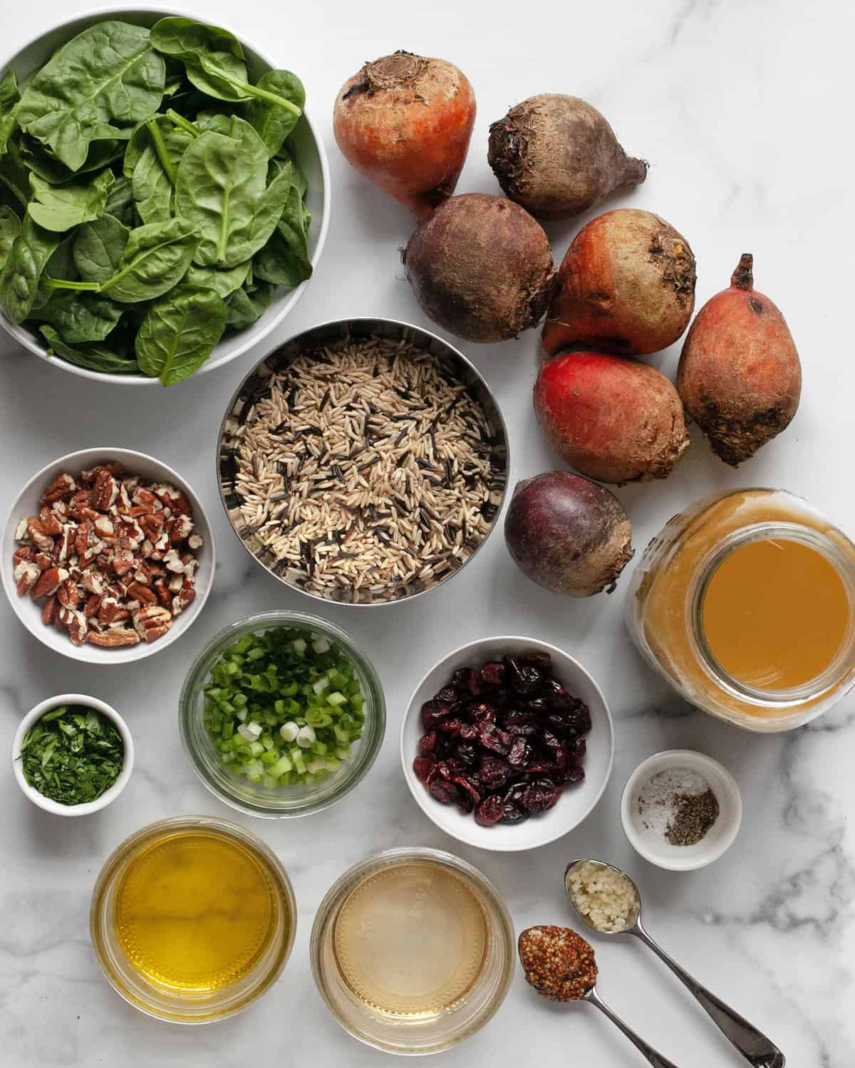 Ingredients including beets, wild rice blend, pecans, scallions, parsley, spinach, dried cranberries, oil, apple cider vinegar, garlic, mustard, salt pepper and vegetable broth.