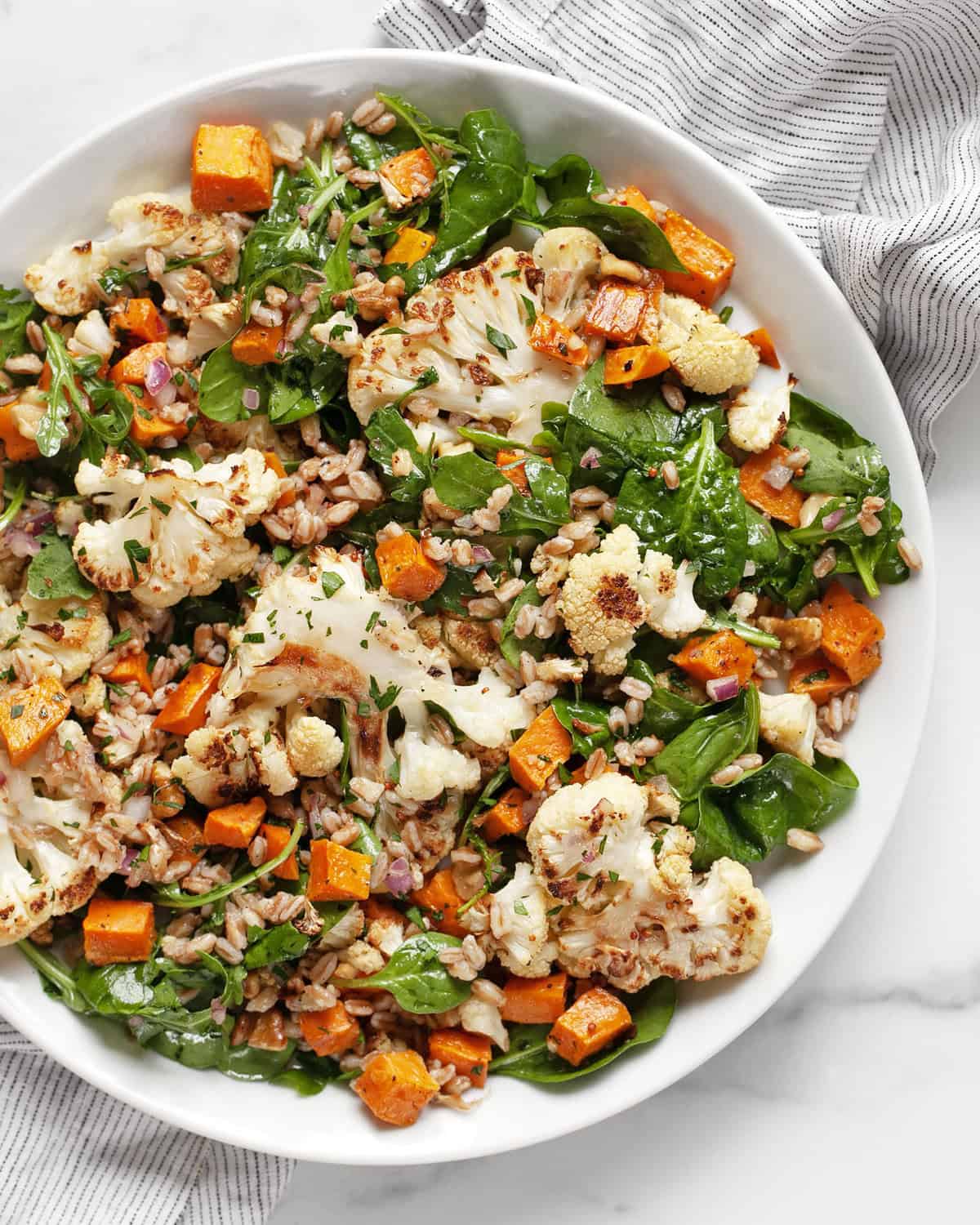 Roasted sweet potato cauliflower salad on a plate.