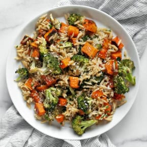 Roasted butternut squash and broccoli orzo on a plate.