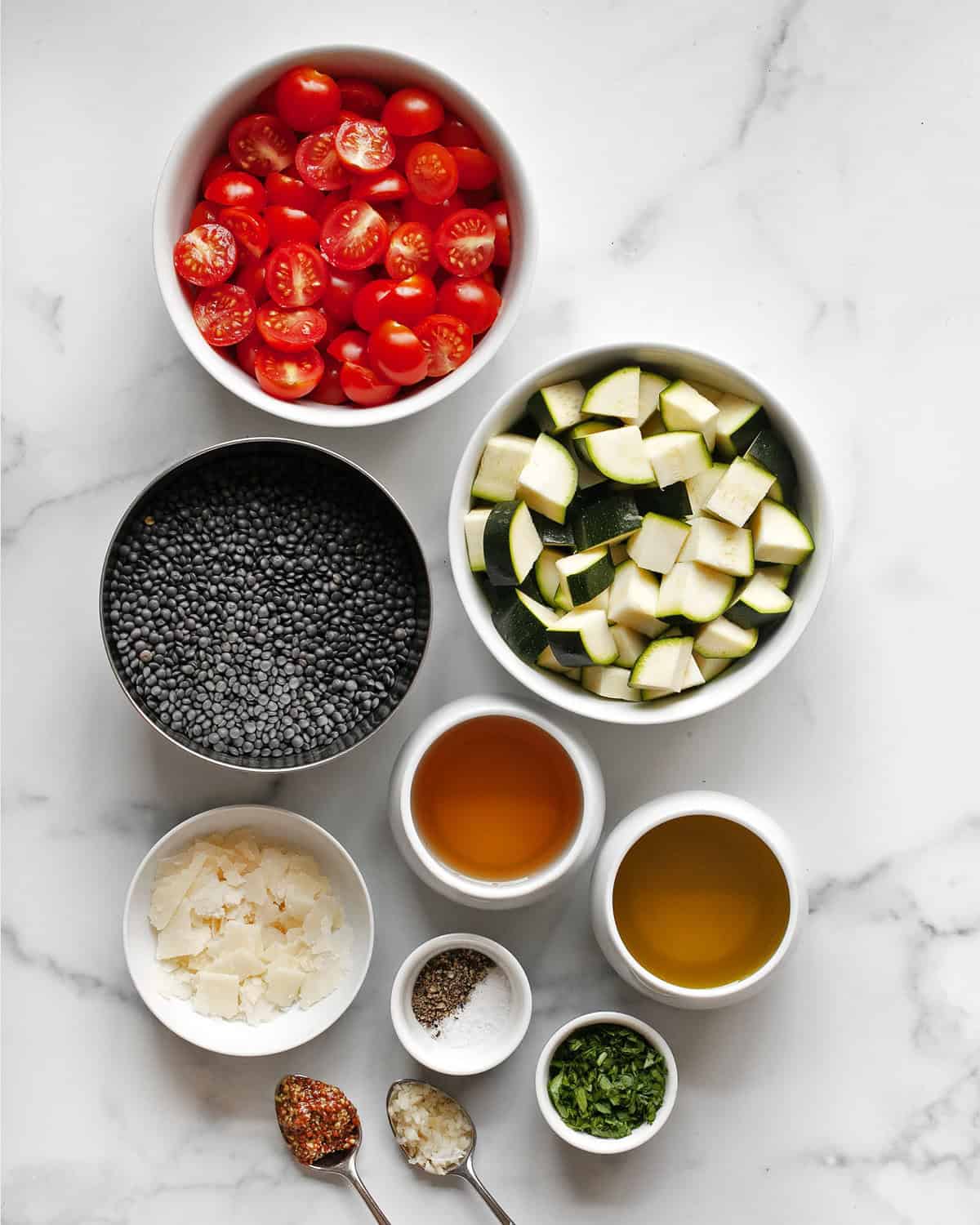 Ingredients including tomatoes, zucchini, black lentils, Parmesan, white balsamic vinegar, olive oil, salt and pepper.