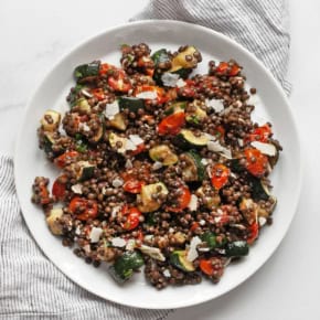 Roasted zucchini tomato lentil salad on a plate.