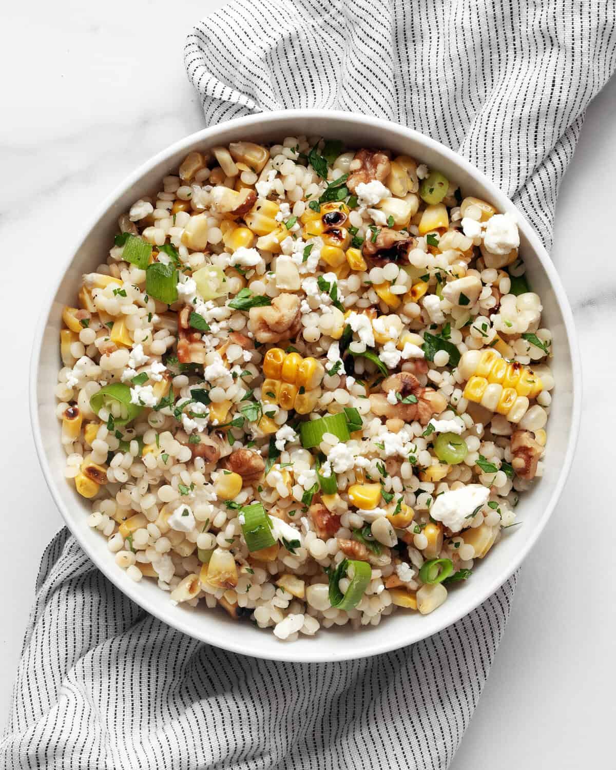 Grilled corn pearl couscous in a bowl.