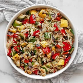 Grilled vegetable orzo salad in a bowl.