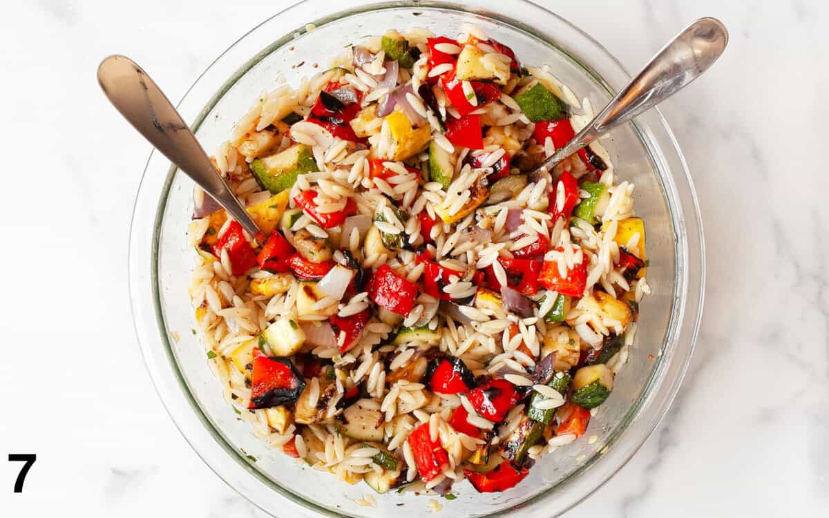 Orzo pasta salad mixed together in a large bowl.