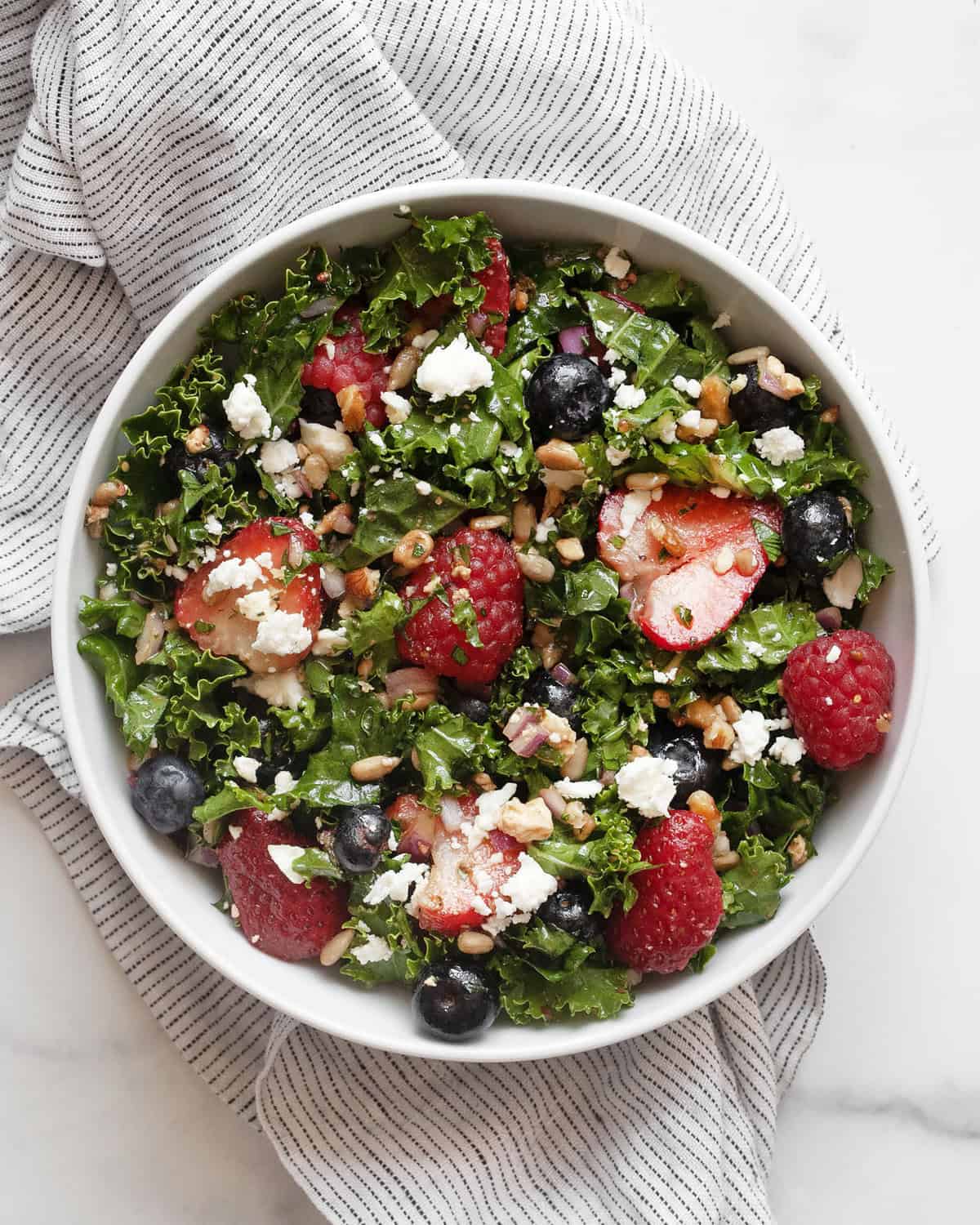 Mixed berry kale salad in a bowl.