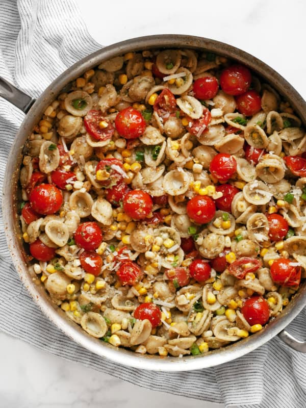 Tomato corn pasta in a skillet.