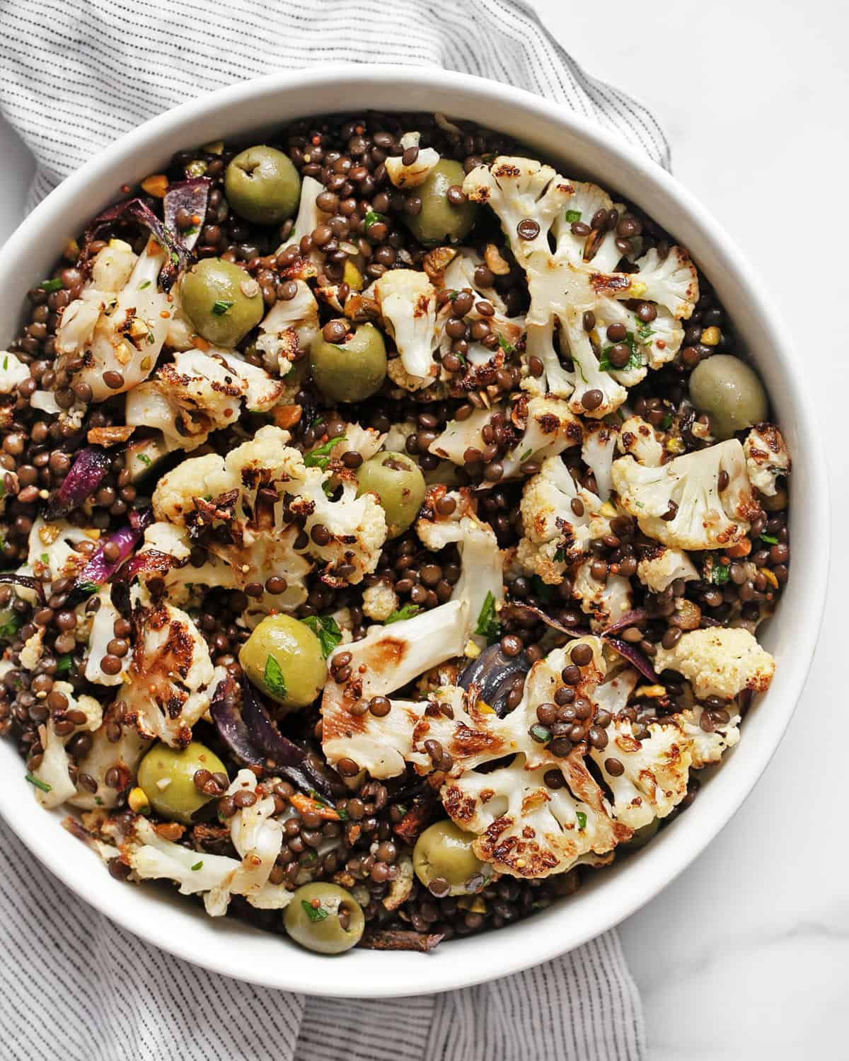 Roasted cauliflower lentil salad in a bowl.