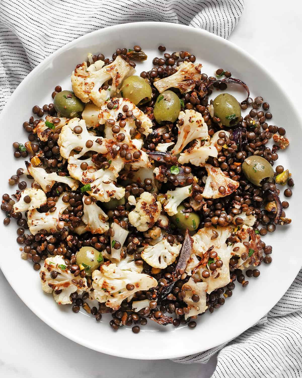 Roasted cauliflower lentil salad on a plate.