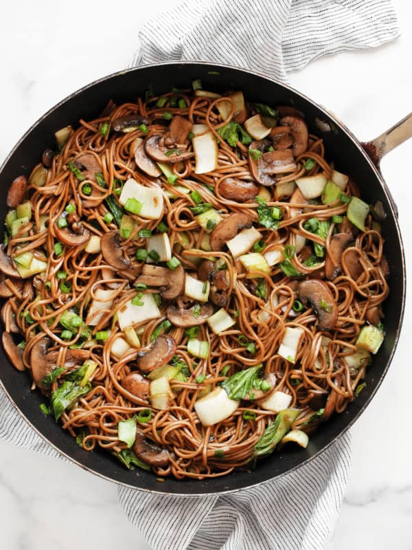 Mushroom and bok choy soba noodle stir-fry in a skillet.