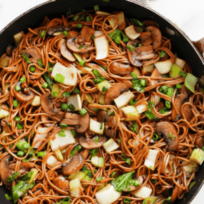 Mushroom and bok choy soba noodle stir-fry in a skillet.