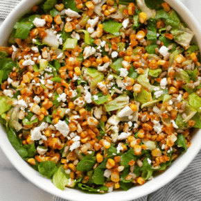 Fresh and crisp, this easy roasted corn salad will be your new favorite chopped salad recipe. I season the corn kernels in a mix of dried spices including cumin, chili powder and paprika before they roast in the oven. That gives the salad a mild kick and tons of flavor and personality. The salad also has crumbled feta, scallions and sunflower seeds and is tossed in a simple white wine vinaigrette.
