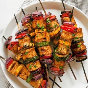 BBQ tofu and vegetable skewers on a plate.