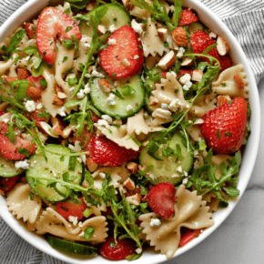 Strawberry cucumber pasta salad in a bowl.