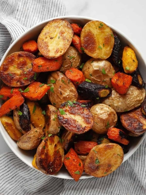 Roasted potatoes and carrots in a bowl.