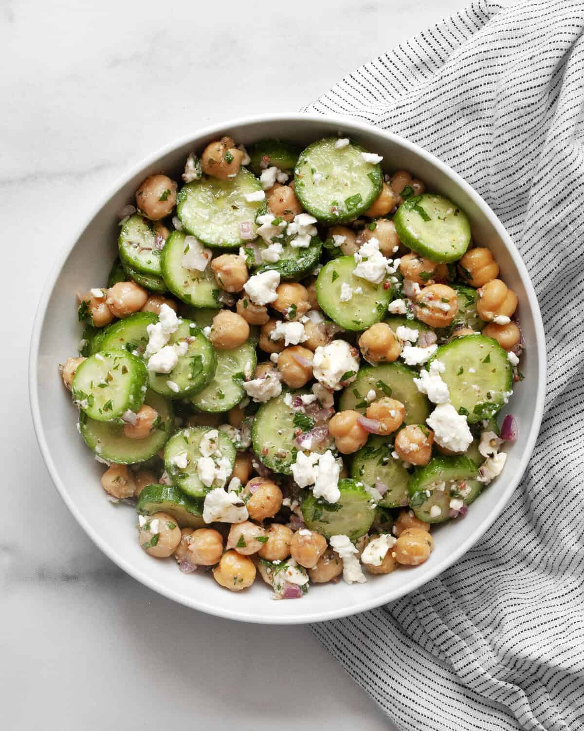 Cucumber chickpea salad in a small bowl.