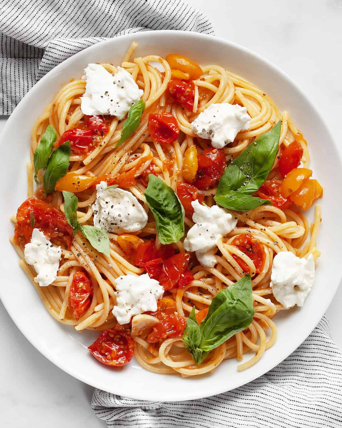 Roasted tomato burrata pasta on a plate.