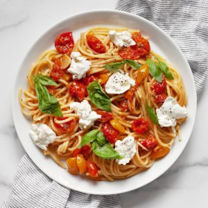 Roasted tomato burrata pasta on a plate.