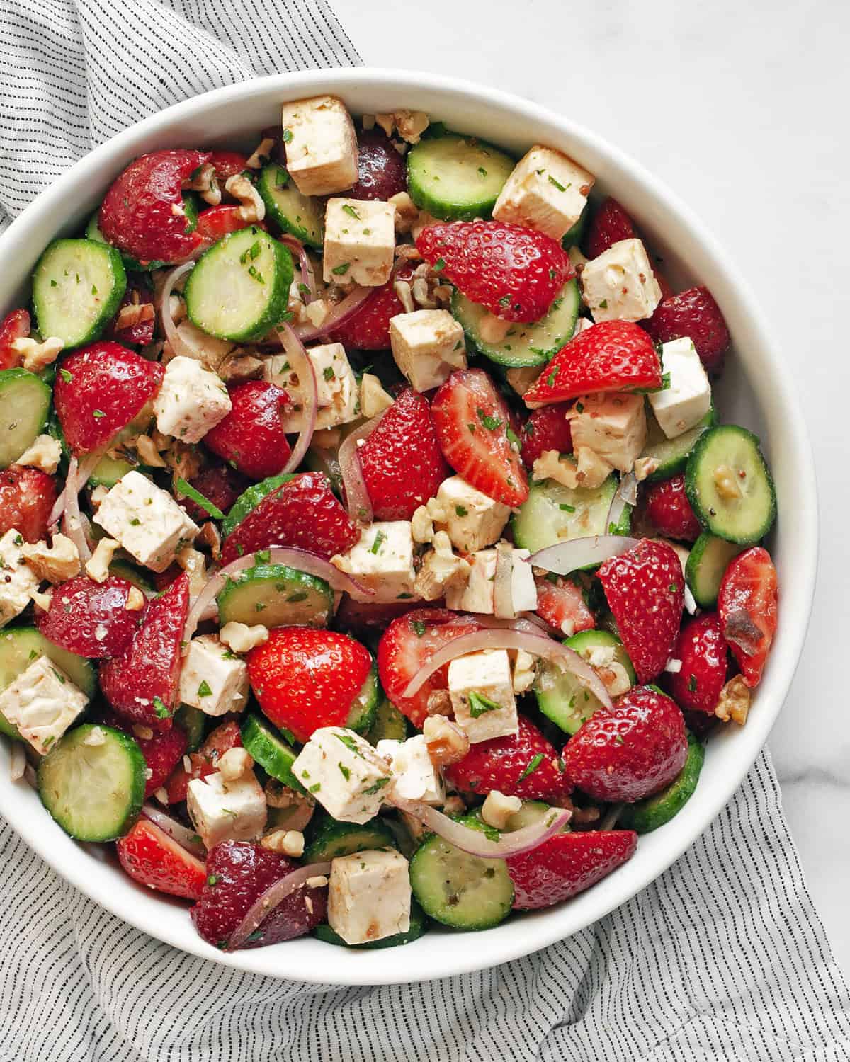 Strawberry cucumber feta salad in a bowl.