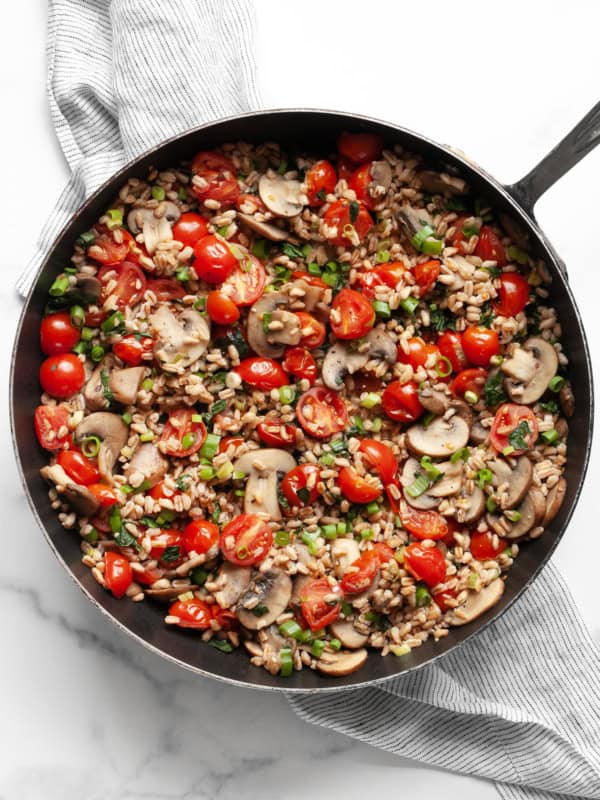 Mushroom tomato farro in a skillet.