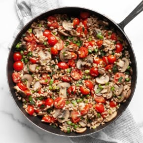 Mushroom tomato farro in a skillet.